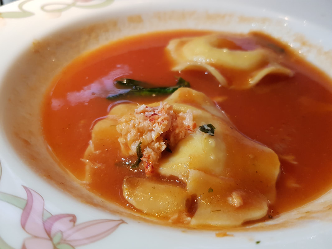 North Atlantic Lobster Ravioli -- with roasted garlic and Sweet Basil in a light tomato broth